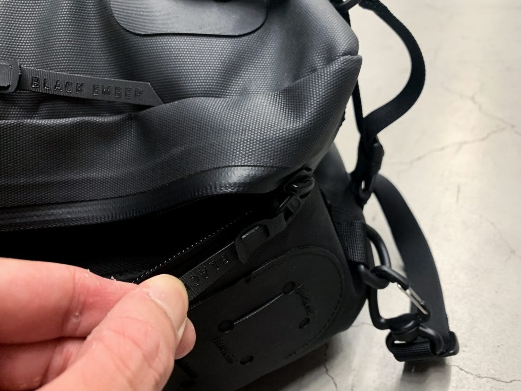 The zip on this black minimalist backpack might get stuck at the corners.
