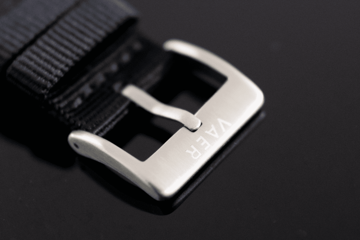 Debossed logo on the nylon strap buckle of the Vaer C5 Watch.